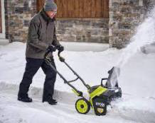 person pushing snow blower