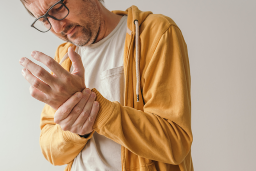 man holding wrist in pain