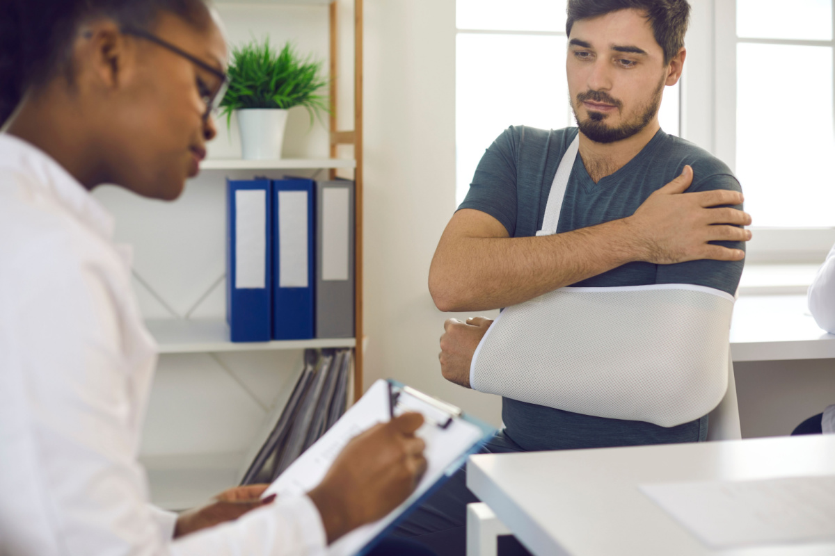 Man getting a fractured shoulder treated by a doctor